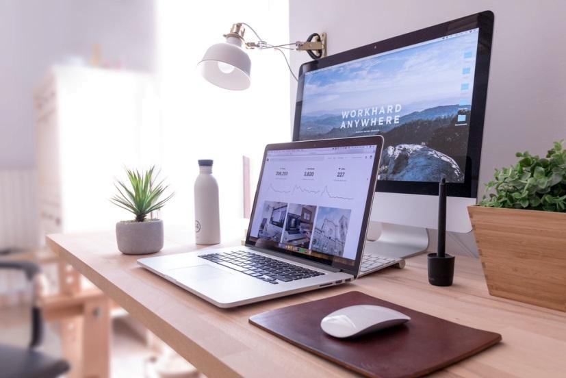 A laptop and a desktop screen
