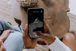 A user using the TikTok application on an iPhone