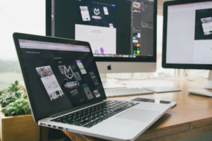A web designer creating a revamped website on their laptop