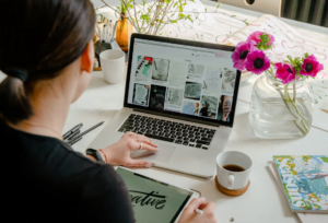 Graphic designer looking for inspiration on her laptop